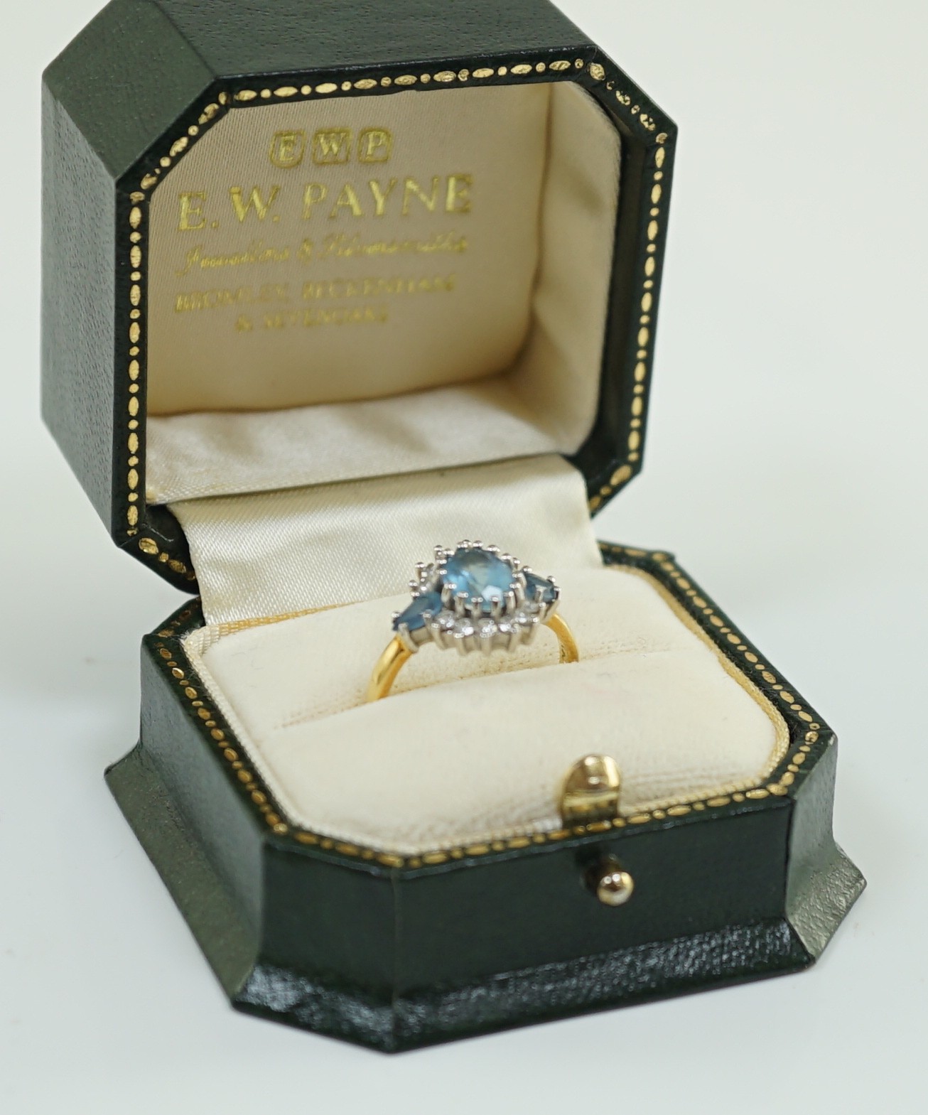 A 1970's 18ct gold, aquamarine and diamond set oval cluster ring, by Cropp & Farr